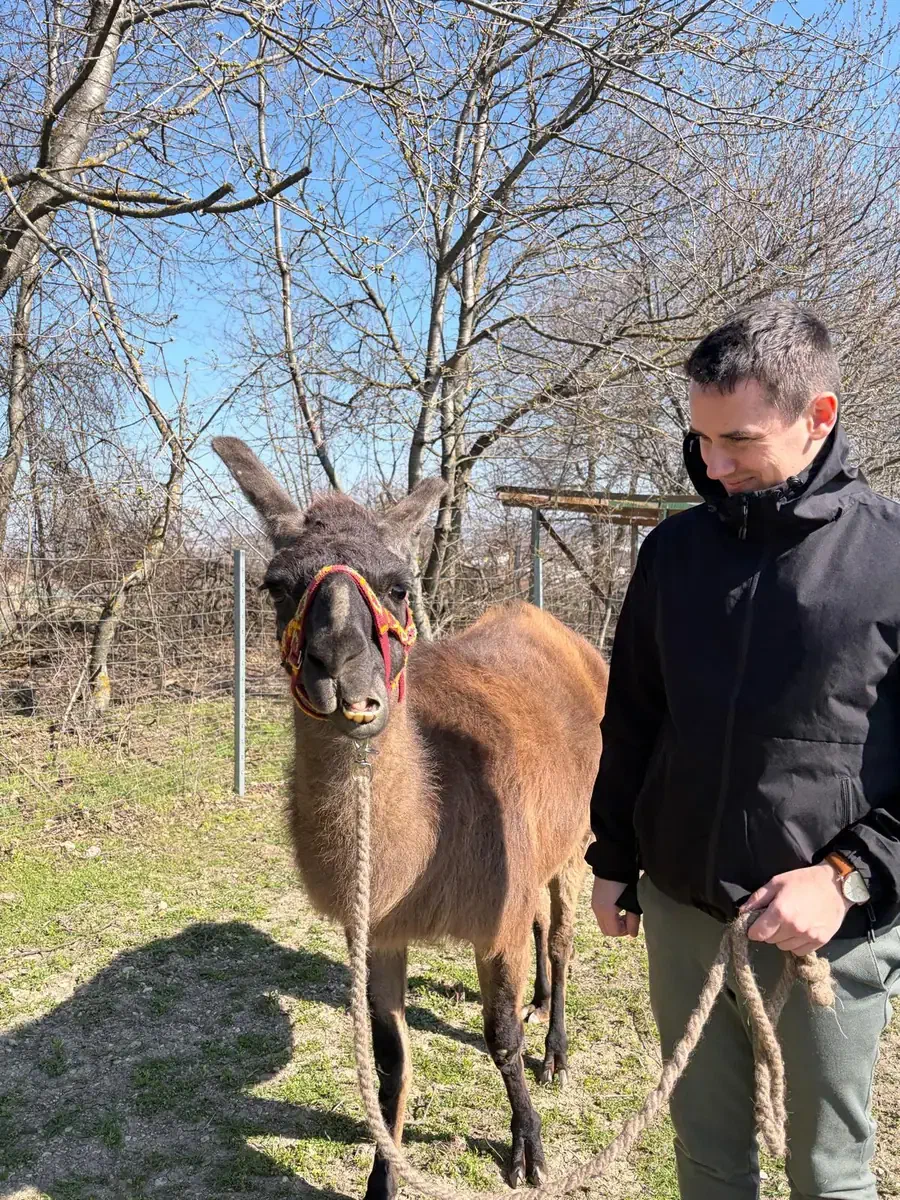 Christof Jori walking beside a donkey outdoors