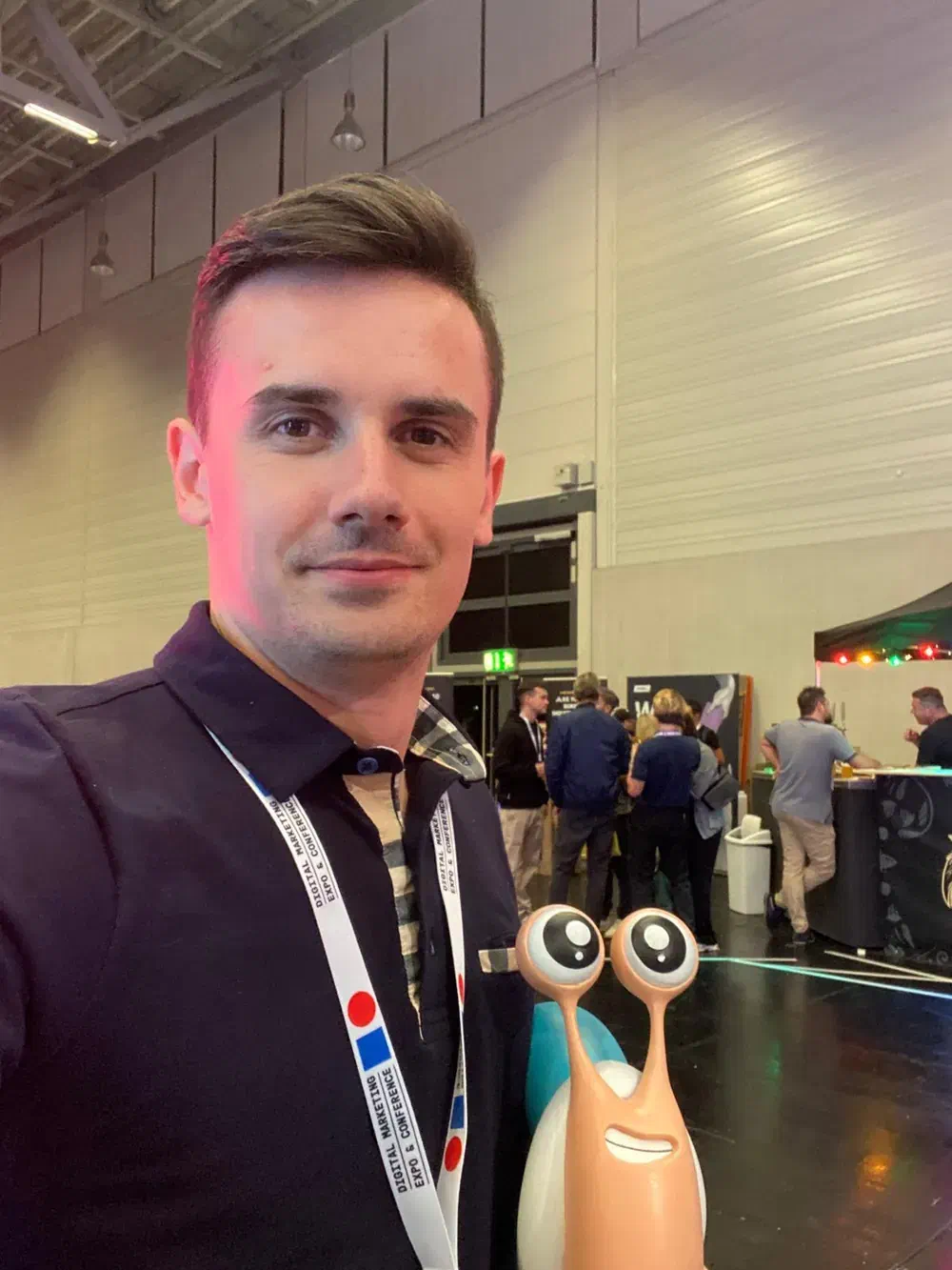 Christof Jori with a small robot at a technology conference