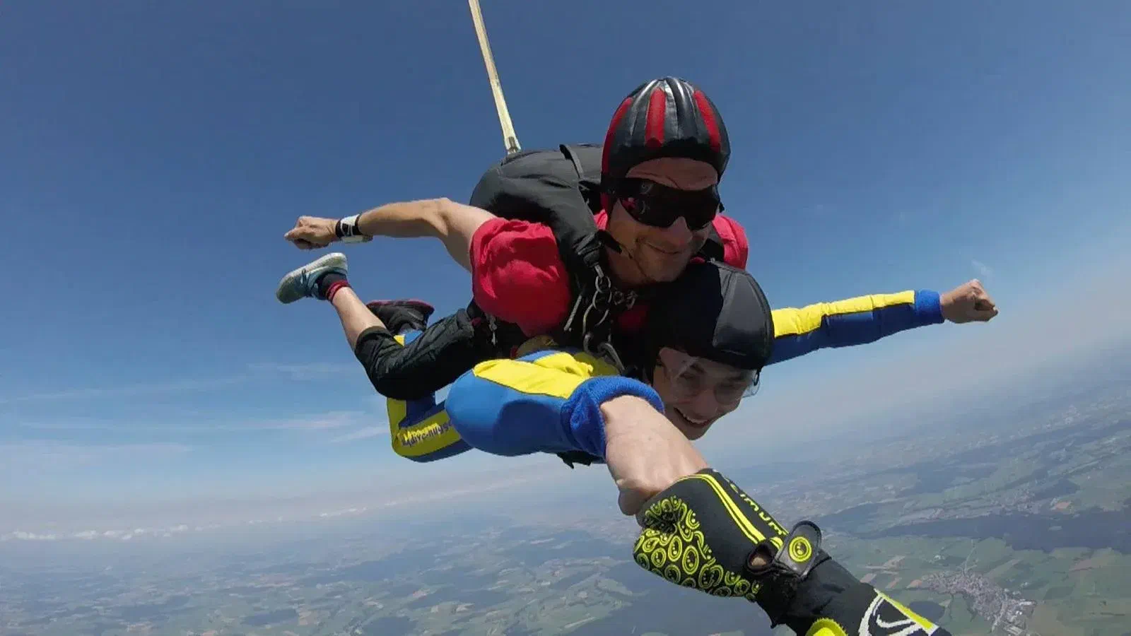 Kevin Riedl tandem skydiving above the Austrian countryside Kevin Riedl tandem skydiving above the Austrian countryside